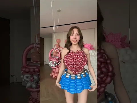 The girl made a balloon dress for her birthday.