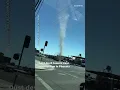 Dust devil towers over Phoenix intersection