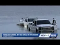 Watch rising tides leave multiple trucks stuck while launching near the Sanibel Causeway