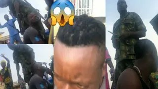 nigerian army cutting hair of a young guy in public