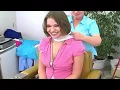 Cute brunette hops into the barber chair