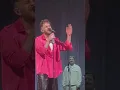 Ben Platt singing waving through a window