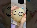 Draw cartoon eyes on a balloon