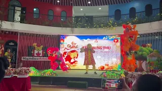 The children get to watch a lion dance in the schoolyard