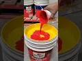 Mixing red stainer yellow exterior emulsion wait for end
