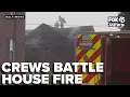 Crews battle north Baltimore house fire