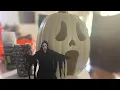 Carving a ghost face scream pumpkin
