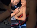 Small boy getting tattooed