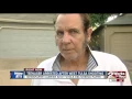 Newspaper carrier shot while delivering papers