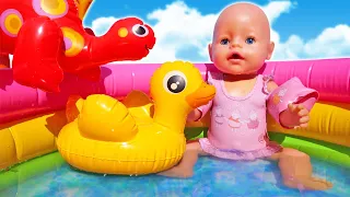 Baby Annabell doll tries swimming in the water pool for kids & eats toy fruits for dolls.