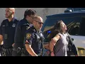 Woman detained after jumping on cars taking off her clothes
