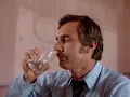 Dennis Weaver enjoys a glass of water and examines his sandwich