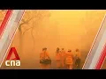 Emergency warnings issued as bushfires combine to form giant blaze in north of Sydney