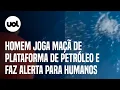 Lagu Homem joga maçã de plataforma de petróleo e diz que isso pode acontecer com humanos caso caiam