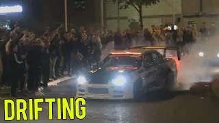 modified cars leaving a car meet nissan skyline r34 drift 